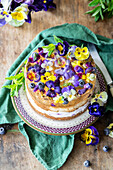 Sponge cake with blueberry cream, champagne jelly and edible flowers