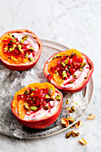 Mini bowls with oranges and pomegranate yogurt