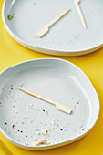 Wooden sticks on cleared plates