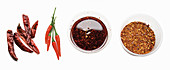 Fresh and dried chilli peppers, chilli oil and chilli flakes