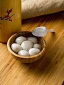Cooked sticky rice balls filled with black sesame seed paste (China)