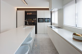 Kücheninsel in moderner weißer Küche mit Marmorboden