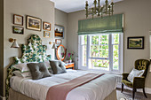 A floral-patterned headboard on a double bed in a Victorian home