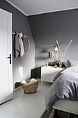 Bedroom with sloping ceiling decorated in grey and white