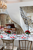 Table festively set in red and white in elegant country house