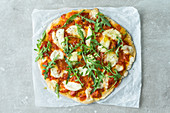 Gluten-free Italian pizza with mozzarella and rocket