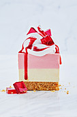 No-bake red skins cheesecake slice with pink chocolate drizzle, strawberry jelly and Italian meringue