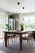 A wooden table with chairs in a dining room