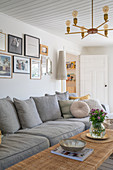 A grey upholstered sofa and a coffee table in a Scandinavian-style living room