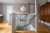 A flight of stairs leading down with a wooden cupboard in the background