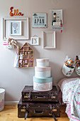 Hat boxes on vintage suitcases in a children's room