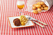 Meatballs with mashed potatoes and celery and mustard
