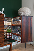 A sideboard as a bar cabinet with lighting and glass shelves