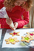 Girl preparing gingerbread stained glass biscuits