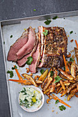 Peppered roast beef with fried cashew and sesame seed potatoes, and coriander mayonnaise