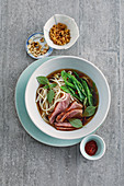 Duck breast in an oriental broth with mange tout and rice noodles