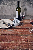 An arrangement of crockery and red wine