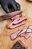 Slicing grilled flank steak against the grain