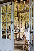 View through open door into room with stone wall