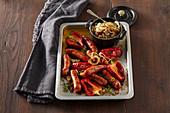 Sausages on beer with red pepper and mustard onion