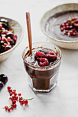 Vegan chocolate millet pudding with raspberries and currants