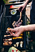 Hands above a grill