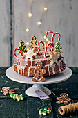 A Bundt cake with lemon glaze decorated with butter biscuits, candy canes and gingerbread men