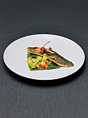 trout served on a bed of mixed vegetables