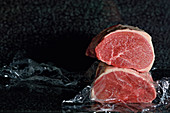 Raw meat against a dark background