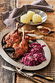 Goose legs with red cabbage and potato dumplings