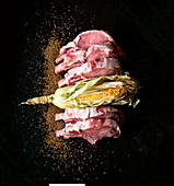 Duroc pork chops, a corn cob and cumin