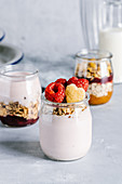 Healthy raspberry parfaits with yogurt in glass jars