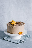 Chocolate nutella cake decorated with kumquat and mini heart shaped cookies