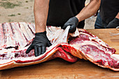 The membrane being removed from flank steak