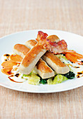 Veal and pork 'Wollwurst' on a bed of creamy savoy cabbage with bacon