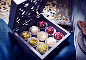 Laddu Box (Indian dessert) with roses, pistachios and coconut