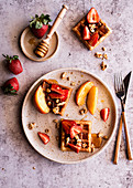 Breakfast waffles with strawberries, peaches and nuts
