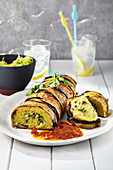 Falafel roulade wrapped in aubergine with a curry-tomato sauce