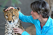 Woman posing with cheetah