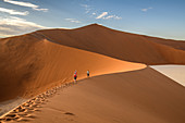 Hikers on sand dune, Namibia