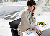 Businesswoman multitasking at desk