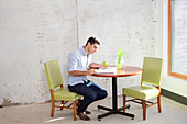 Businessman reading at table in office