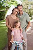 Portrait of smiling parents with daughter