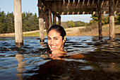 Smiling woman swimming in lake