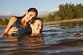 Portrait of smiling couple swimming