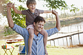 Father carrying smiling son