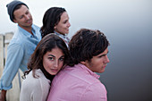 Couples sitting on dock over lake