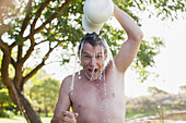 Man pouring water overhead