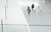 Businessmen meeting at circle of chairs