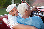 Older couple sitting in convertible